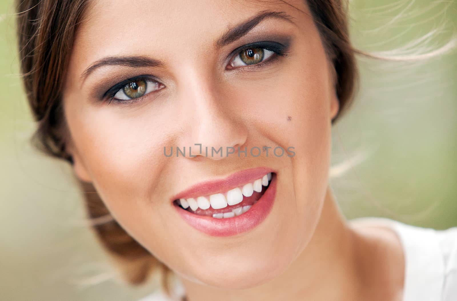 Portrait of beautiful young caucasian woman with makeup outdoors