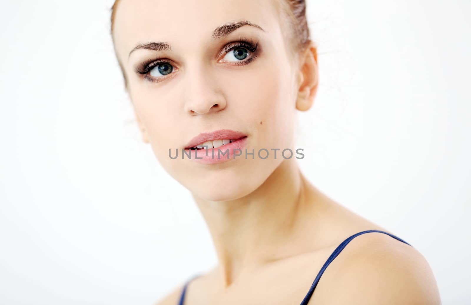 Portrait of a beautiful girl who is looking away over a white background