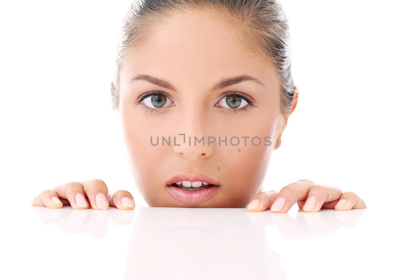 Portrait of a beautiful woman who is hiding and looks like she is playing over a white background