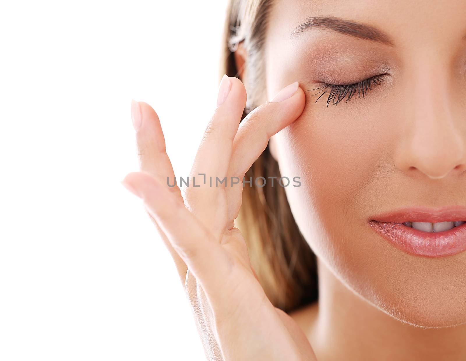 Portrait of a beautiful woman touching her face with her eyes closed