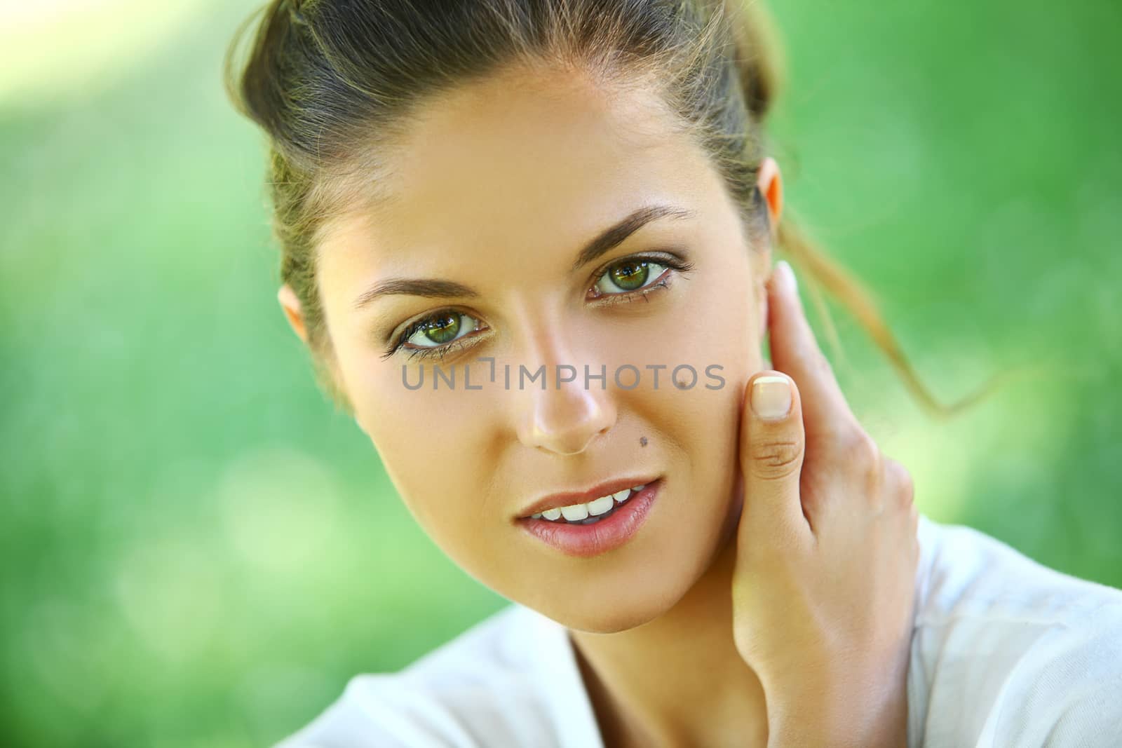 Beautiful young caucasian woman on a green background