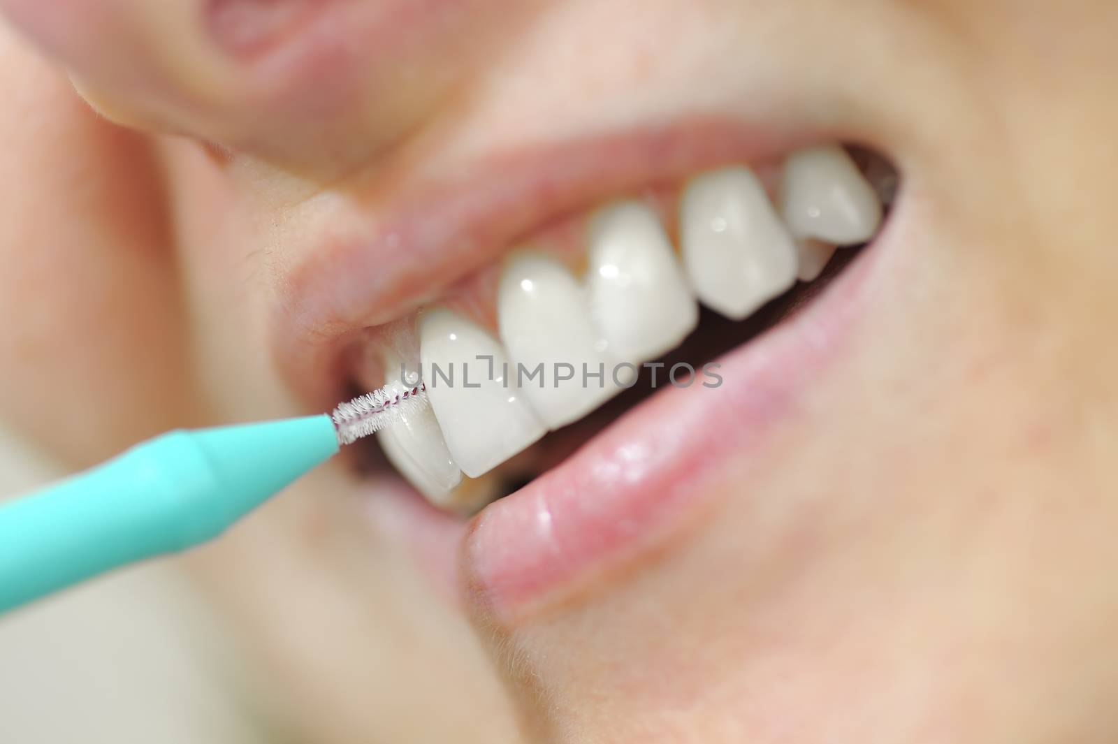 young woman using an interdental brush