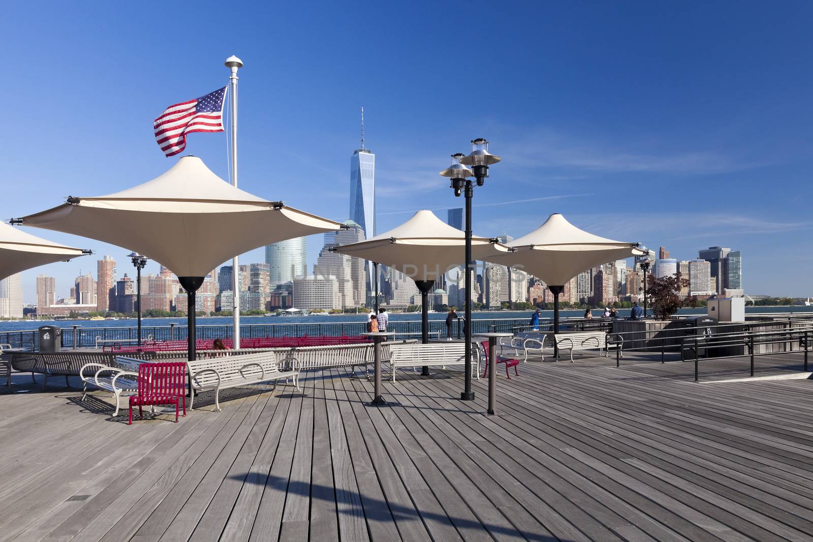 Jersey City, USA-October 3, 2014: Hudson River waterfront park at Exchange Place is named in honor J.Owen Grundy. Amazing view of the Freedom Tower and of lower Manhattan