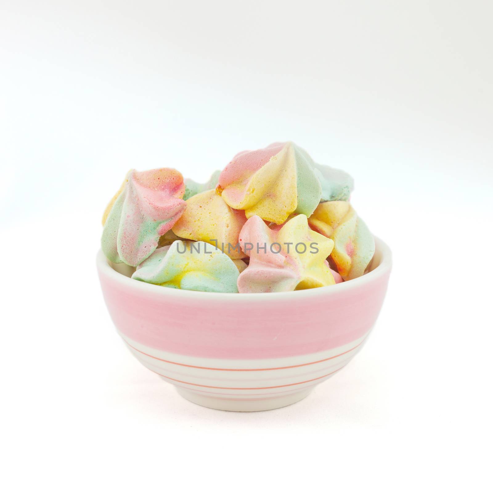 French rainbow meringue cookies on white background by nopparats