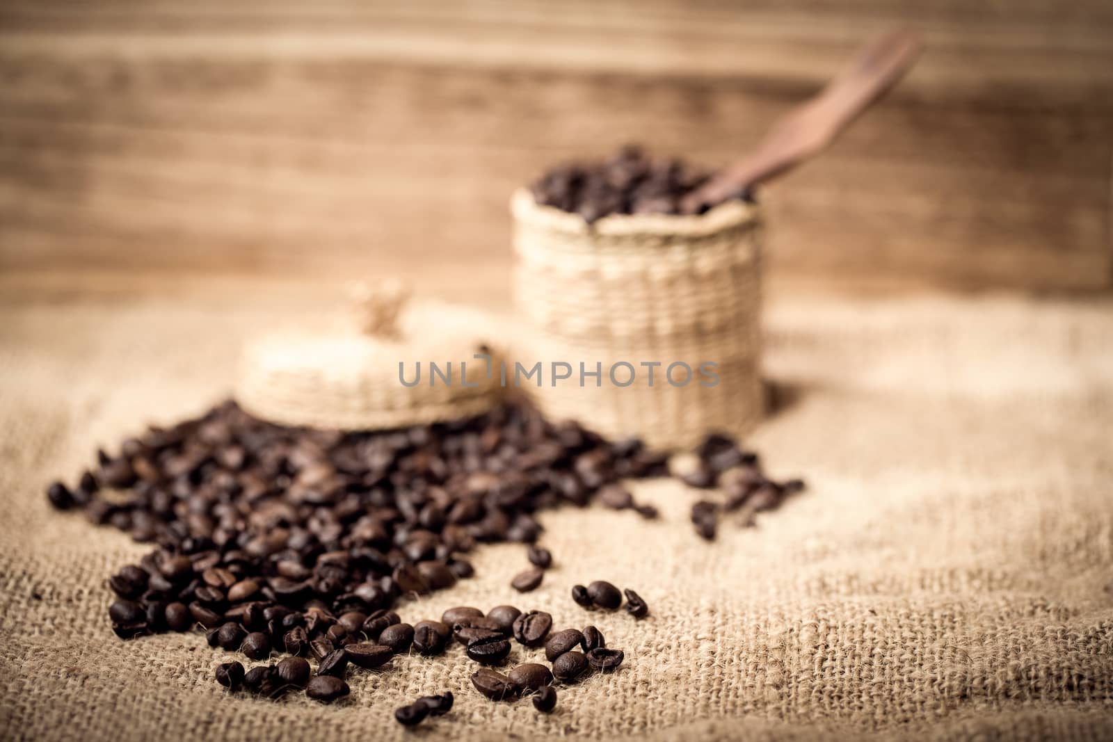 pile of coffee beans and wooden spoon in jar with space for text