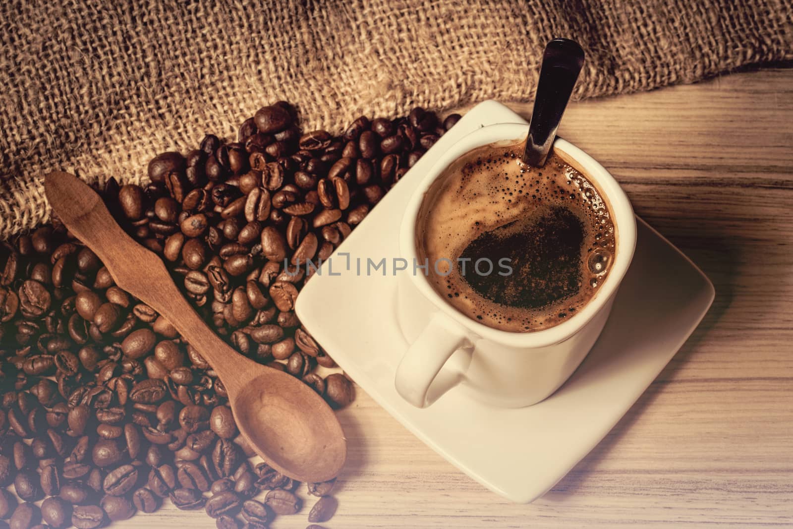 pile of fresh beans, mug, and spoon in retro color tone with space for text