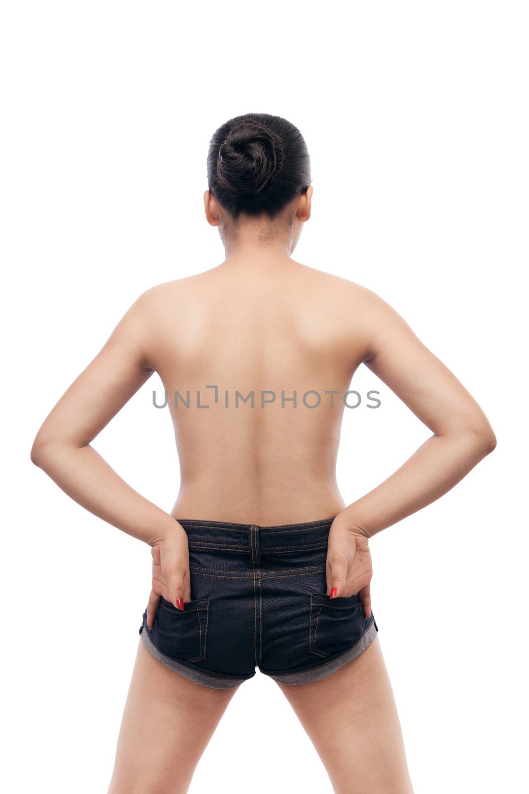 Young indian woman showing her smooth skinned back in blue jeans with their hands in back pocket isolated over white background