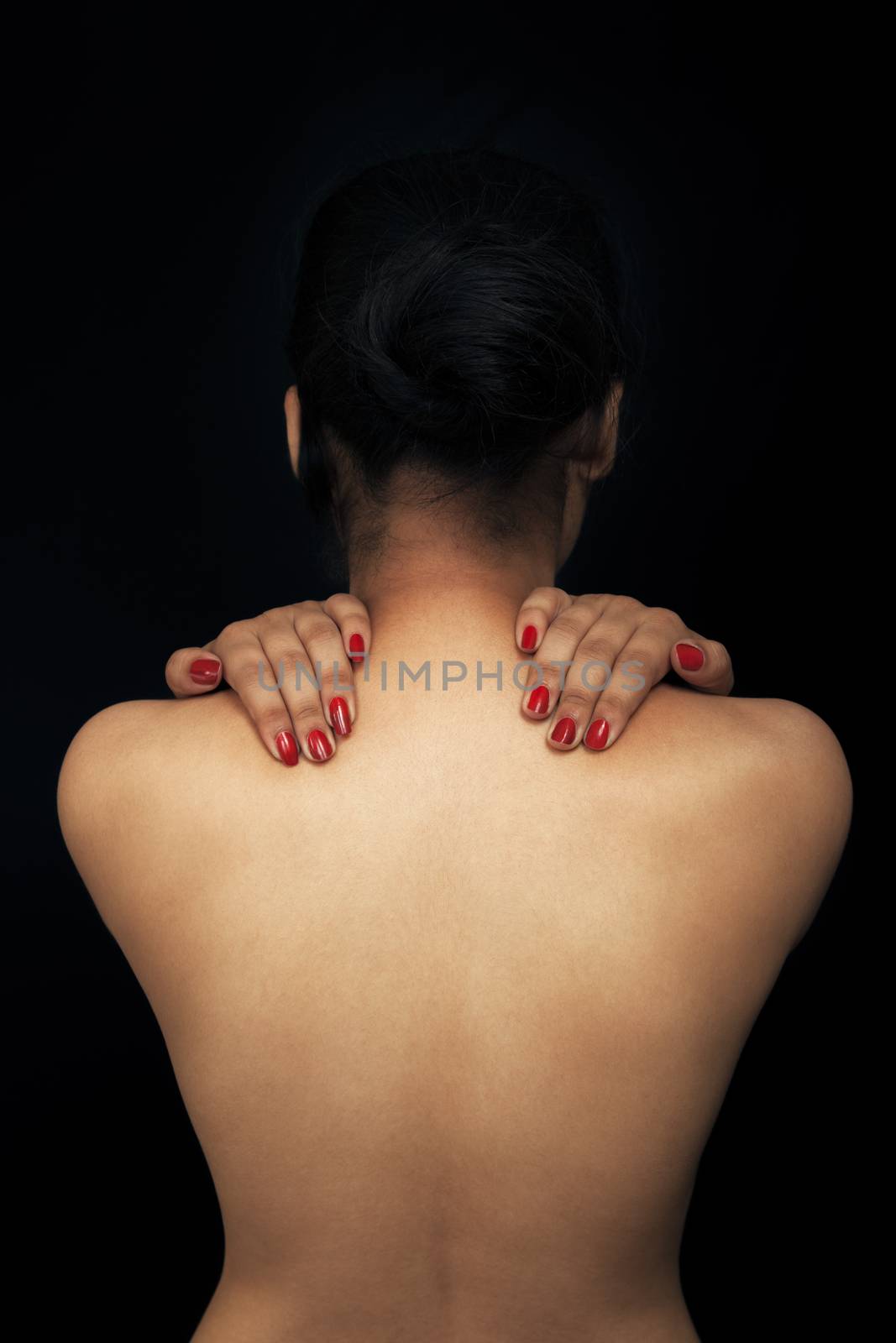 Close up Sexy back of young Indian woman isolated over black background