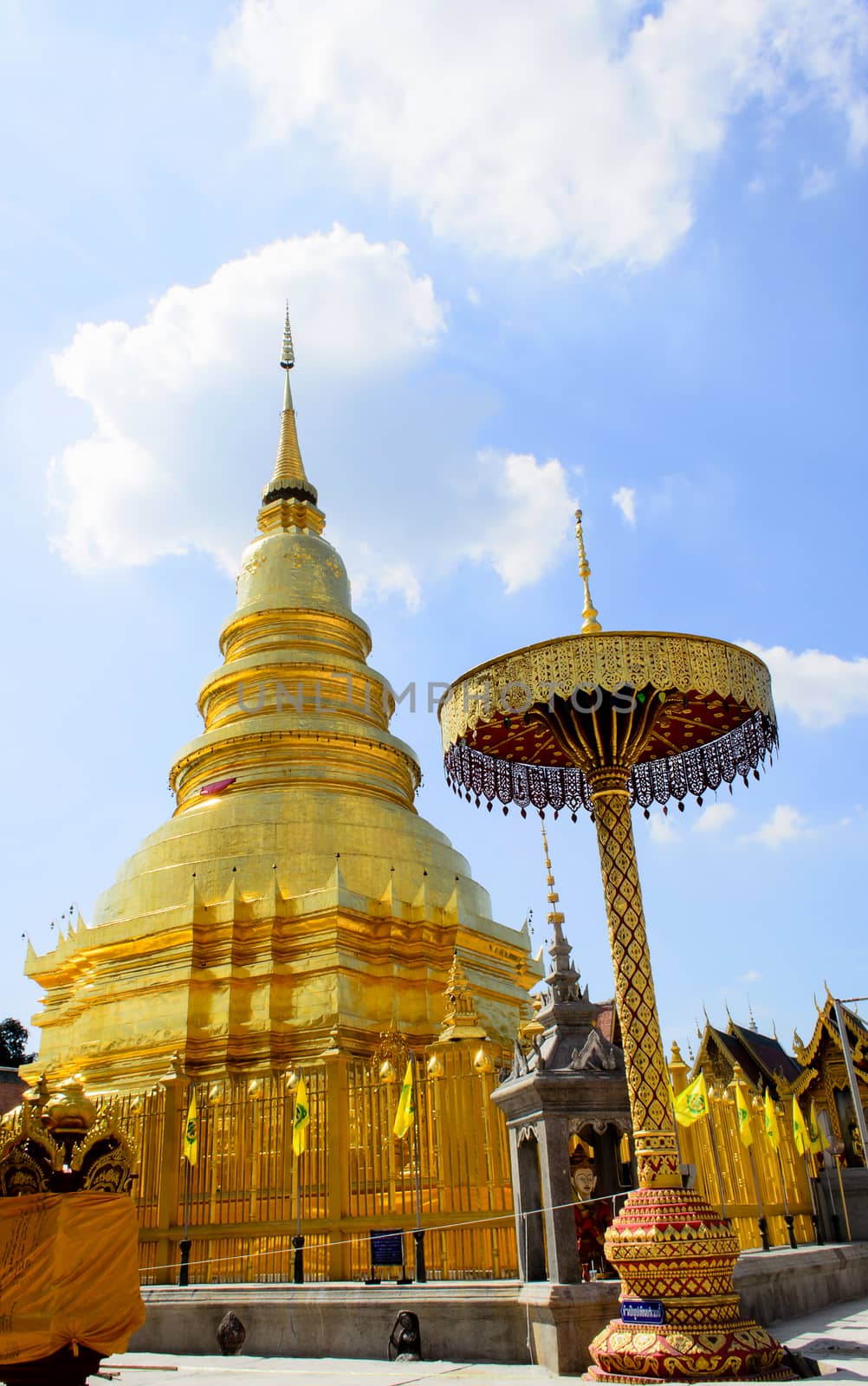 The Golden Pagoda and blue Sky at Wat Phra Tad Haripunchai,Thailand.