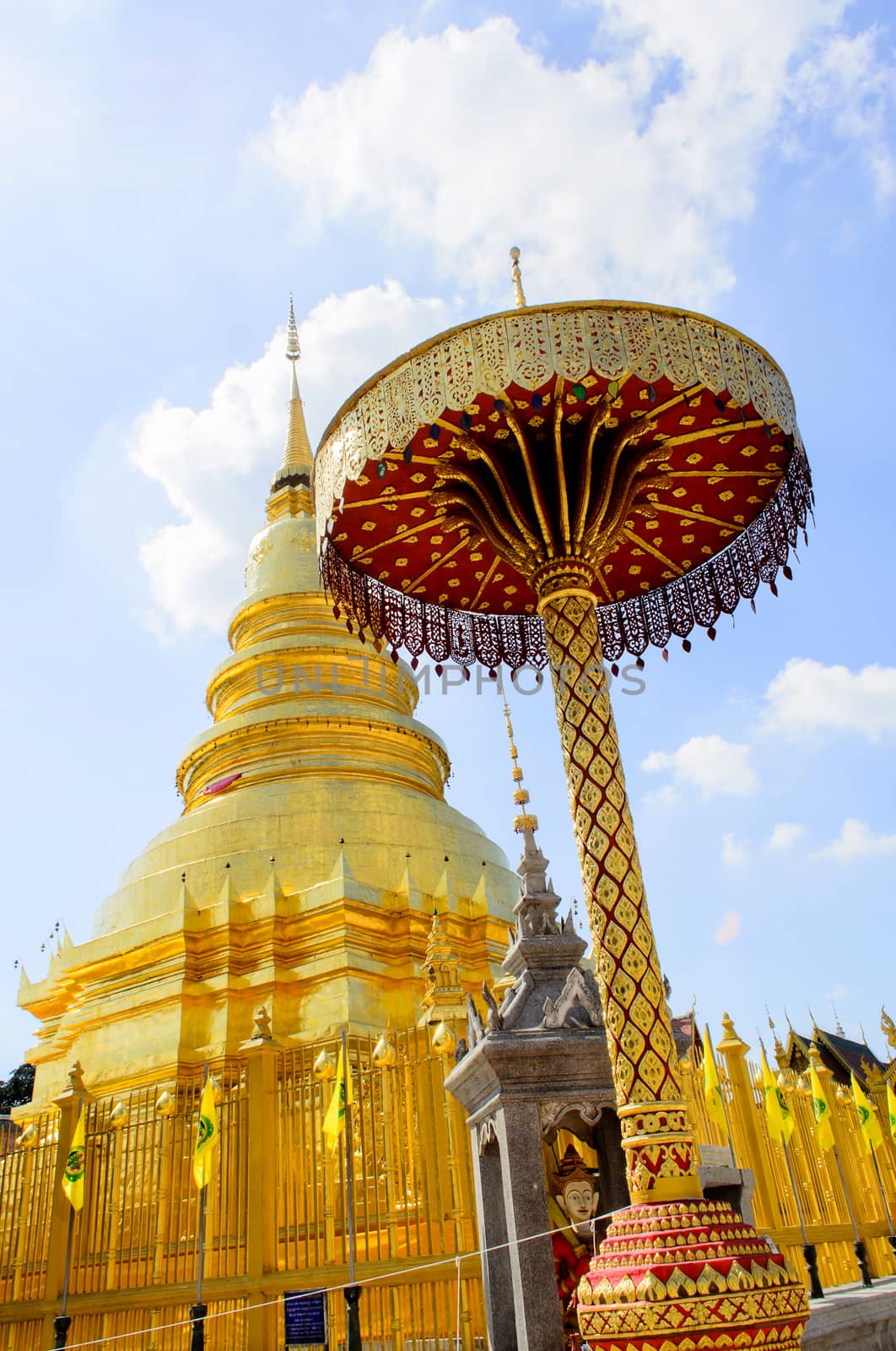 The Golden Pagoda and blue Sky at Wat Phra Tad Haripunchai,Thailand.