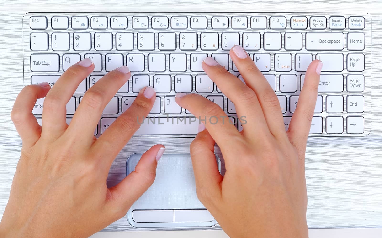 Keyboard Typing.female texting on a white laptop keyboard