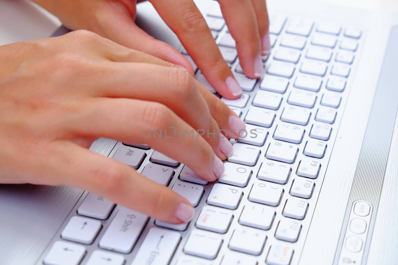 Keyboard Typing.female texting on a white laptop keyboard