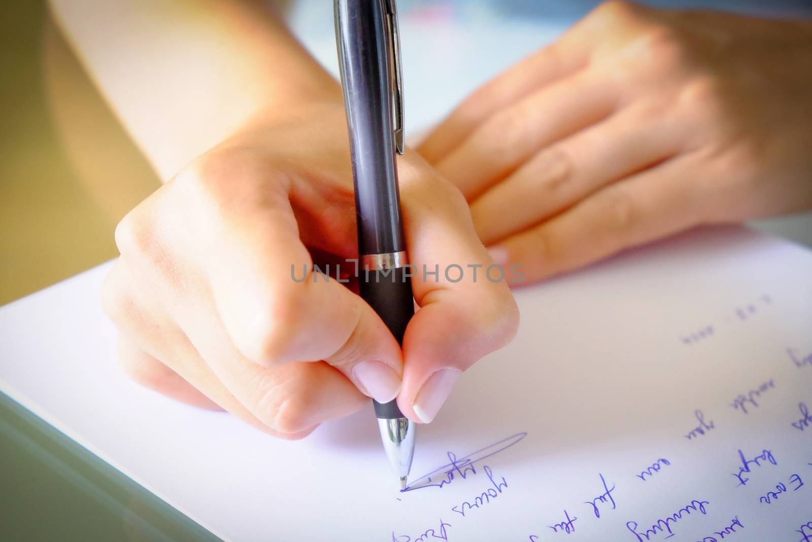 Writing a letter.girl writing a letter with a black pen