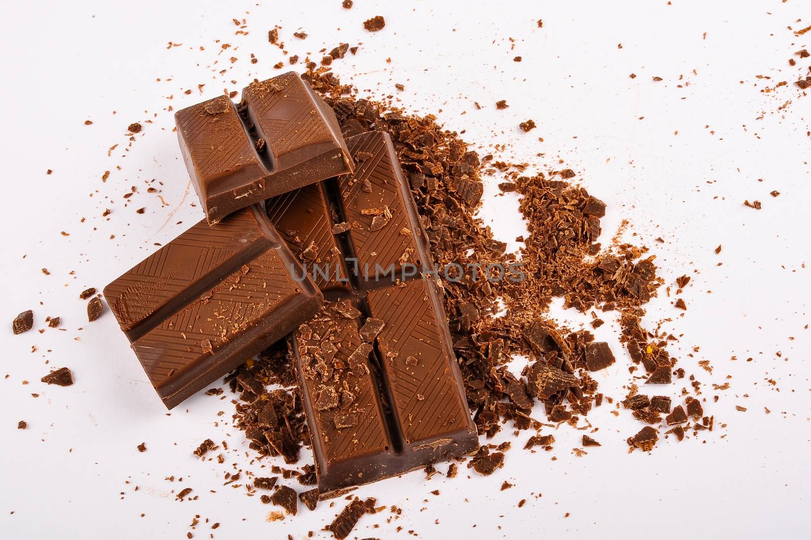 Raw dark chocolate bars on white background