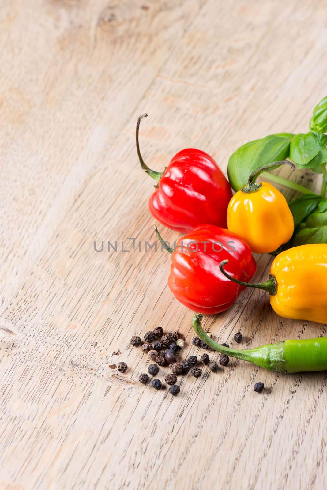 View on peppers and tomato  on old wooden table copy space