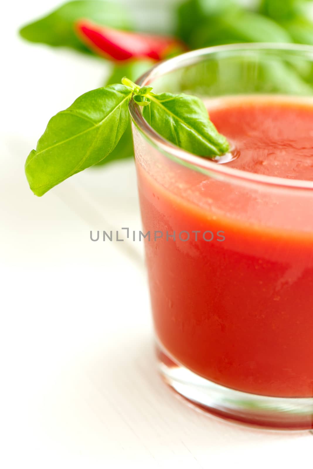 Tomato juice basil leaf on white wooden table background