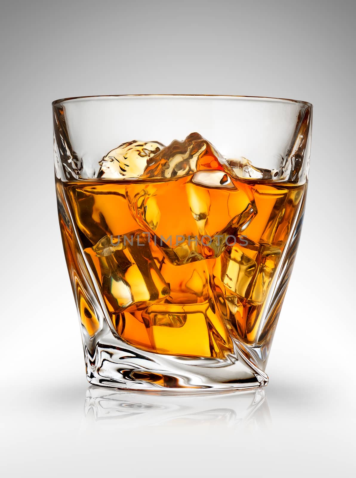 Glass of whiskey on a gray background