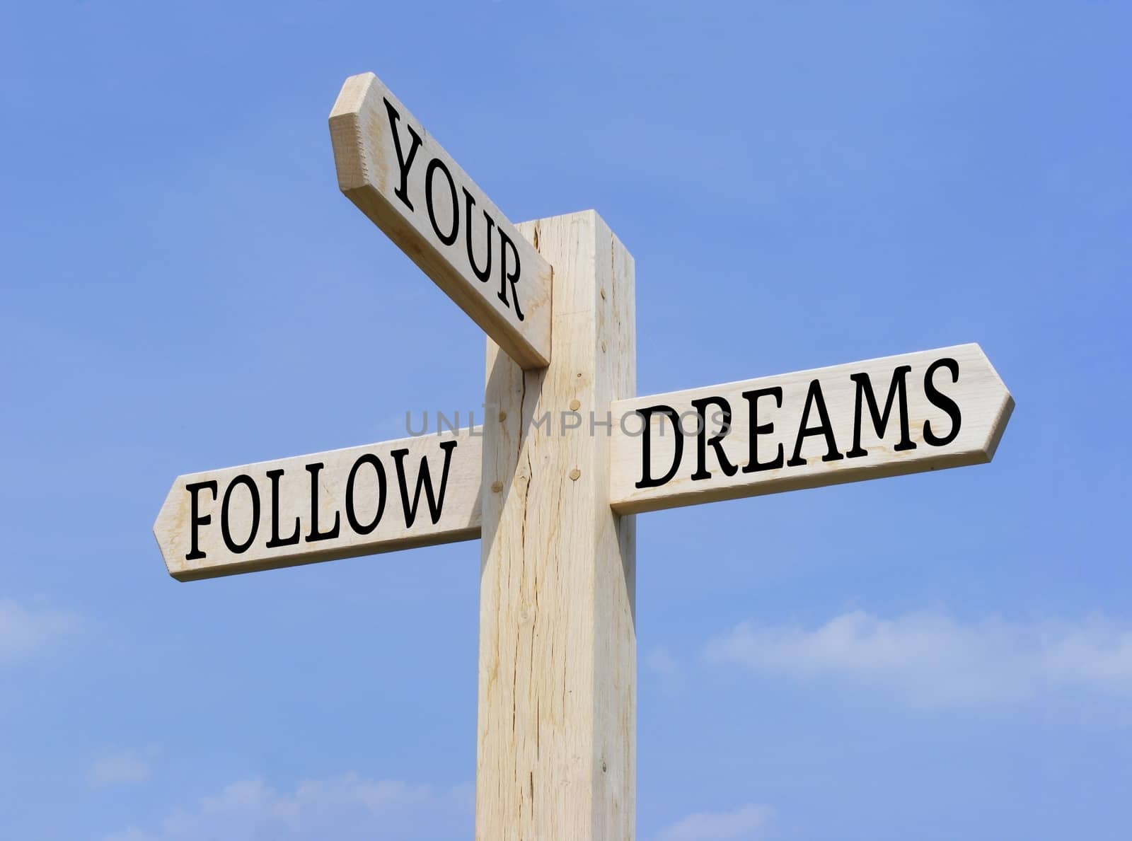 Signpost with the words "Follow Your Dreams" over a blue sky background