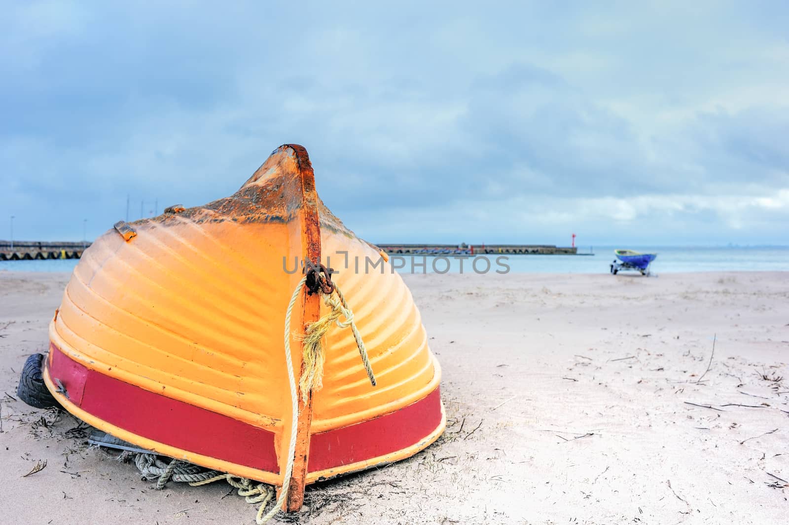 Wooden boat inverted bottom up on the sandy beach