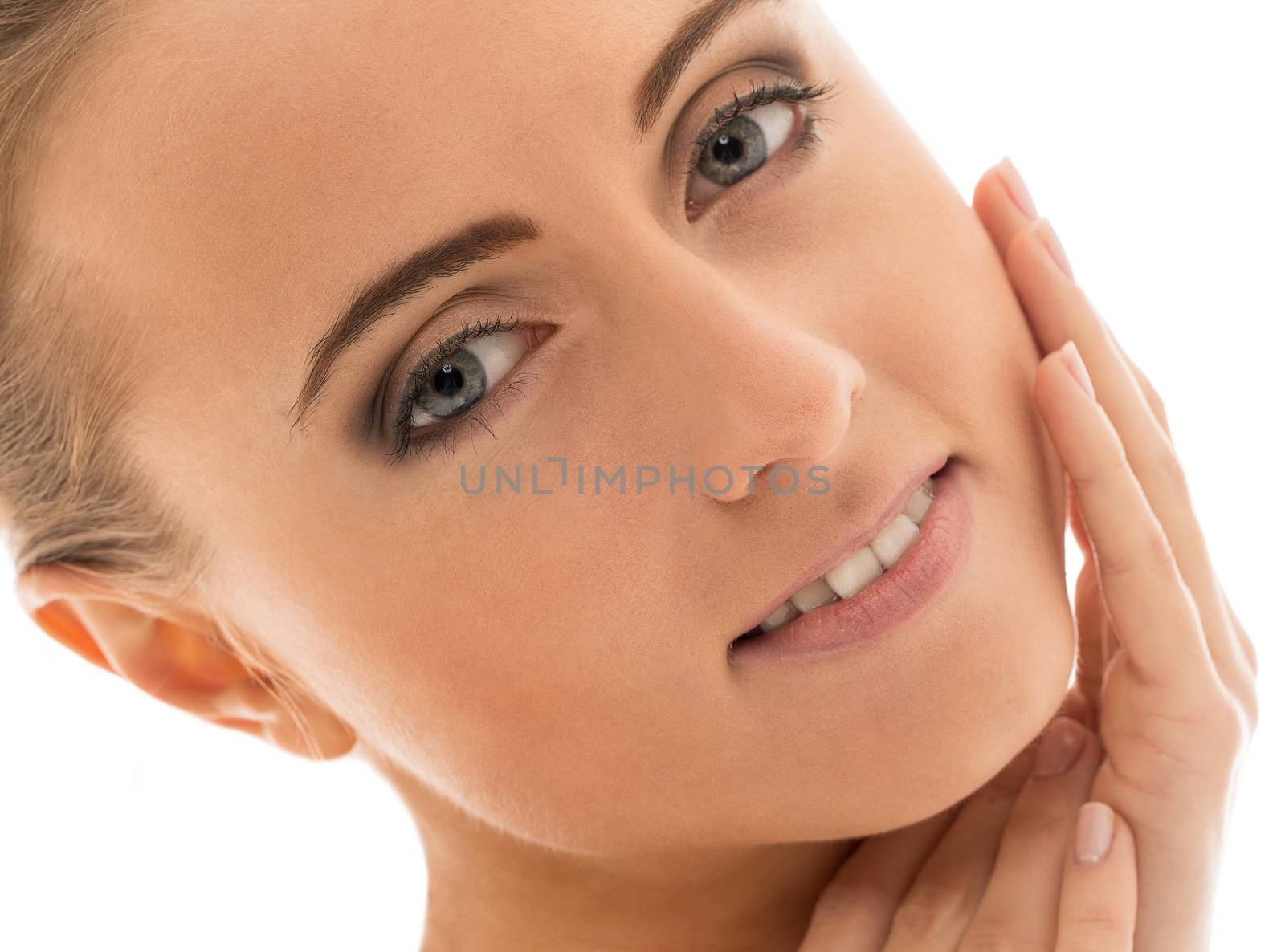 Portrait of a beautiful girl with naked shoulders who is posing over a white background