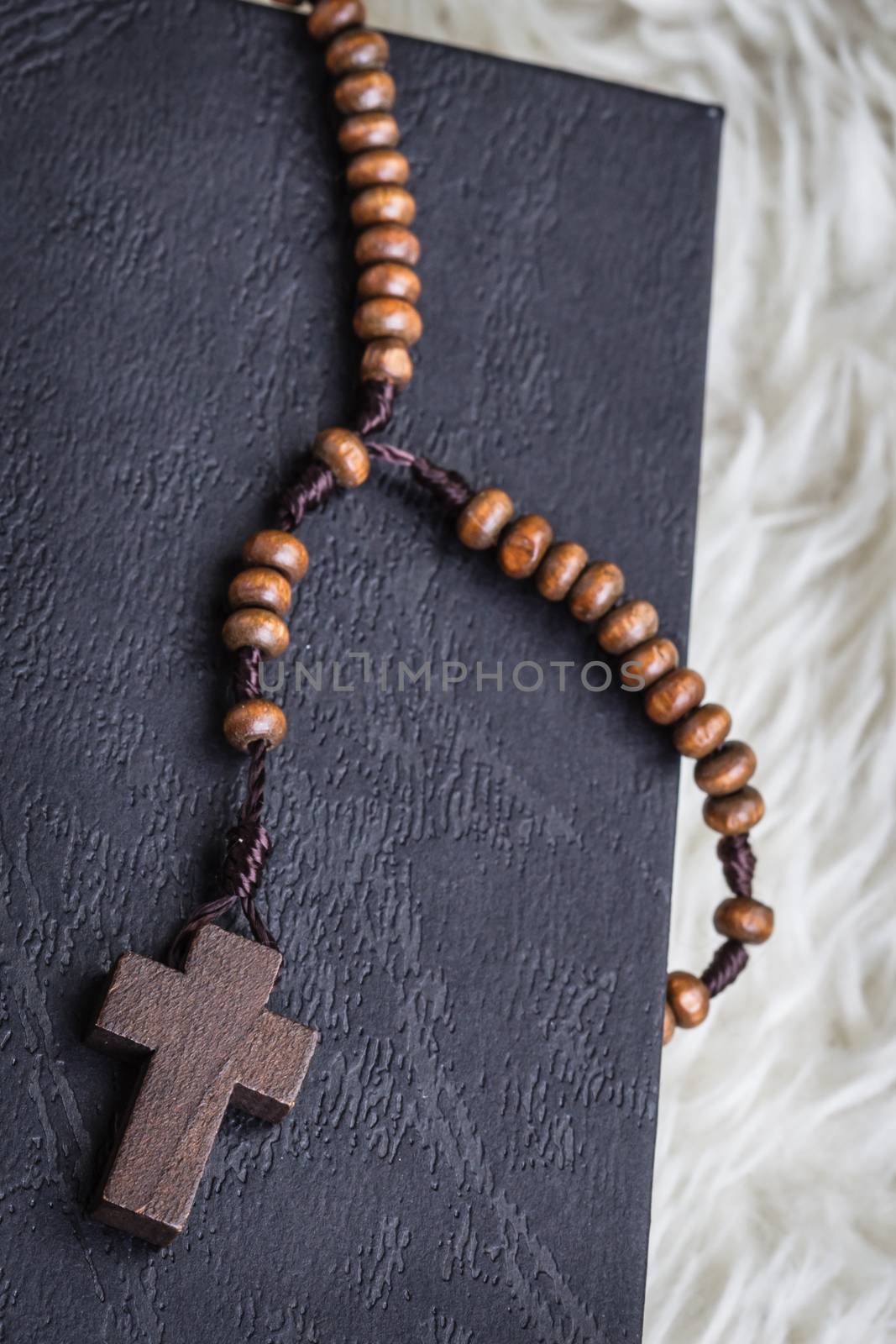 Christian cross necklace on Holy Bible book, Jesus religion concept as good friday or easter festival