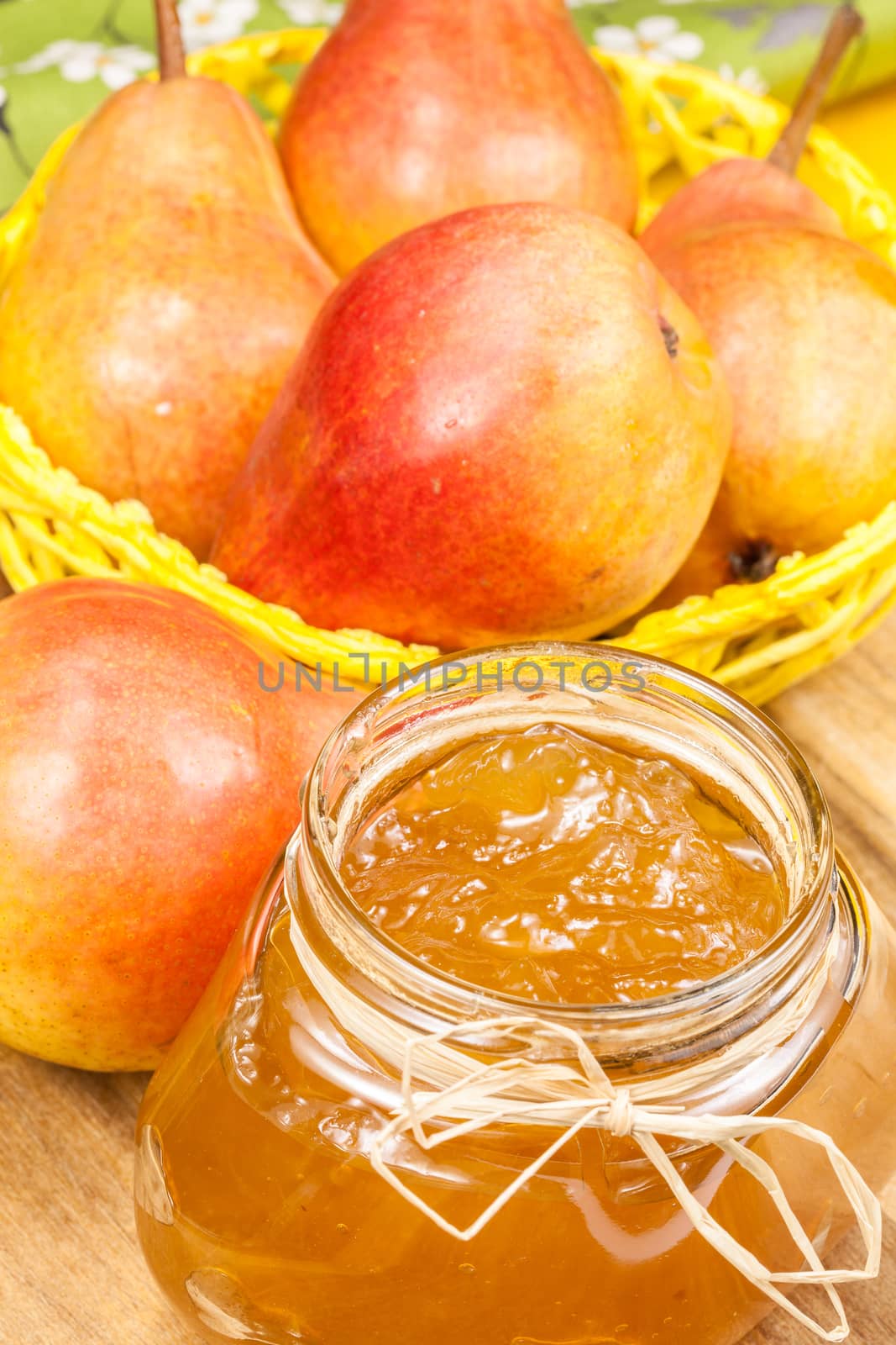 Pear jam in a glass jar and fresh fruits