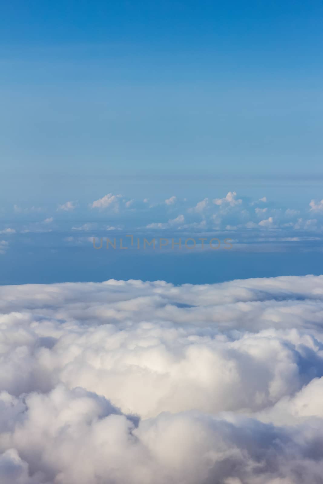 Soft clouds over view from airplane flying