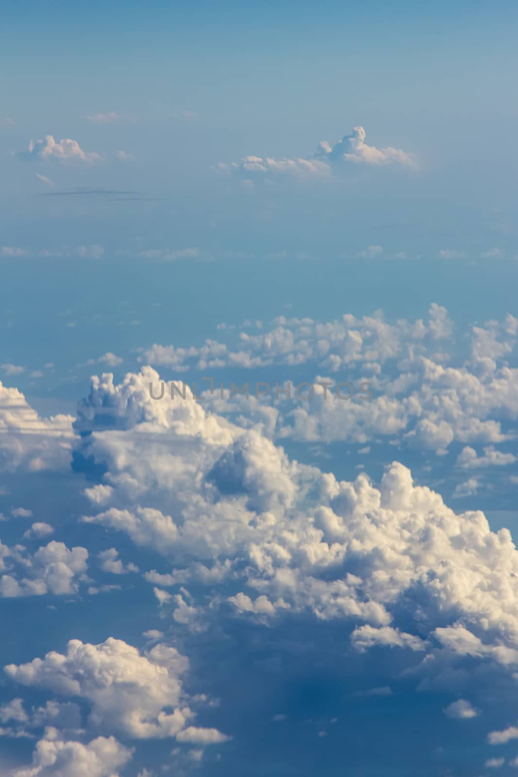 Soft clouds over view from airplane flying