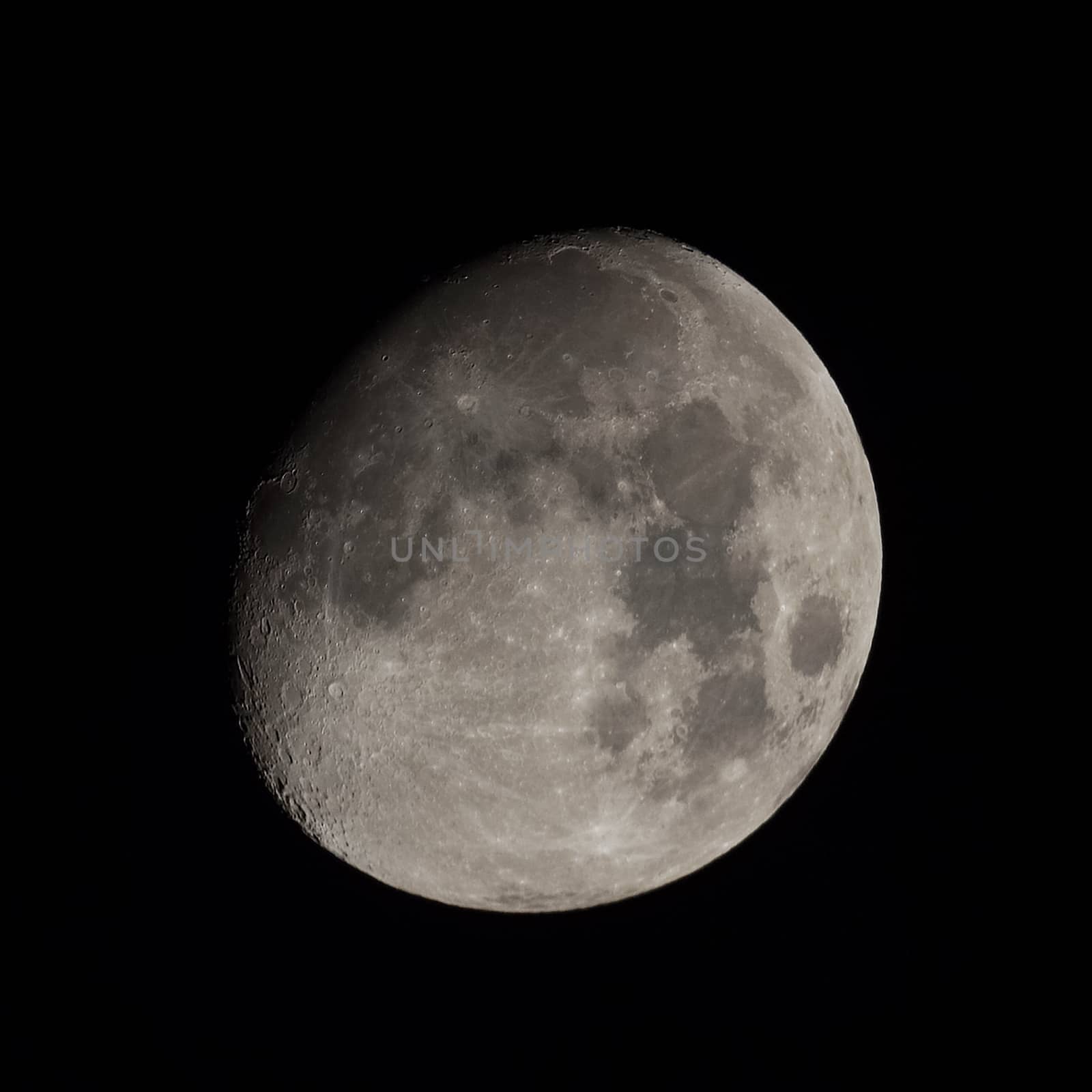 Almost full moon over dark black sky at night seen with a telescope from northern emisphere