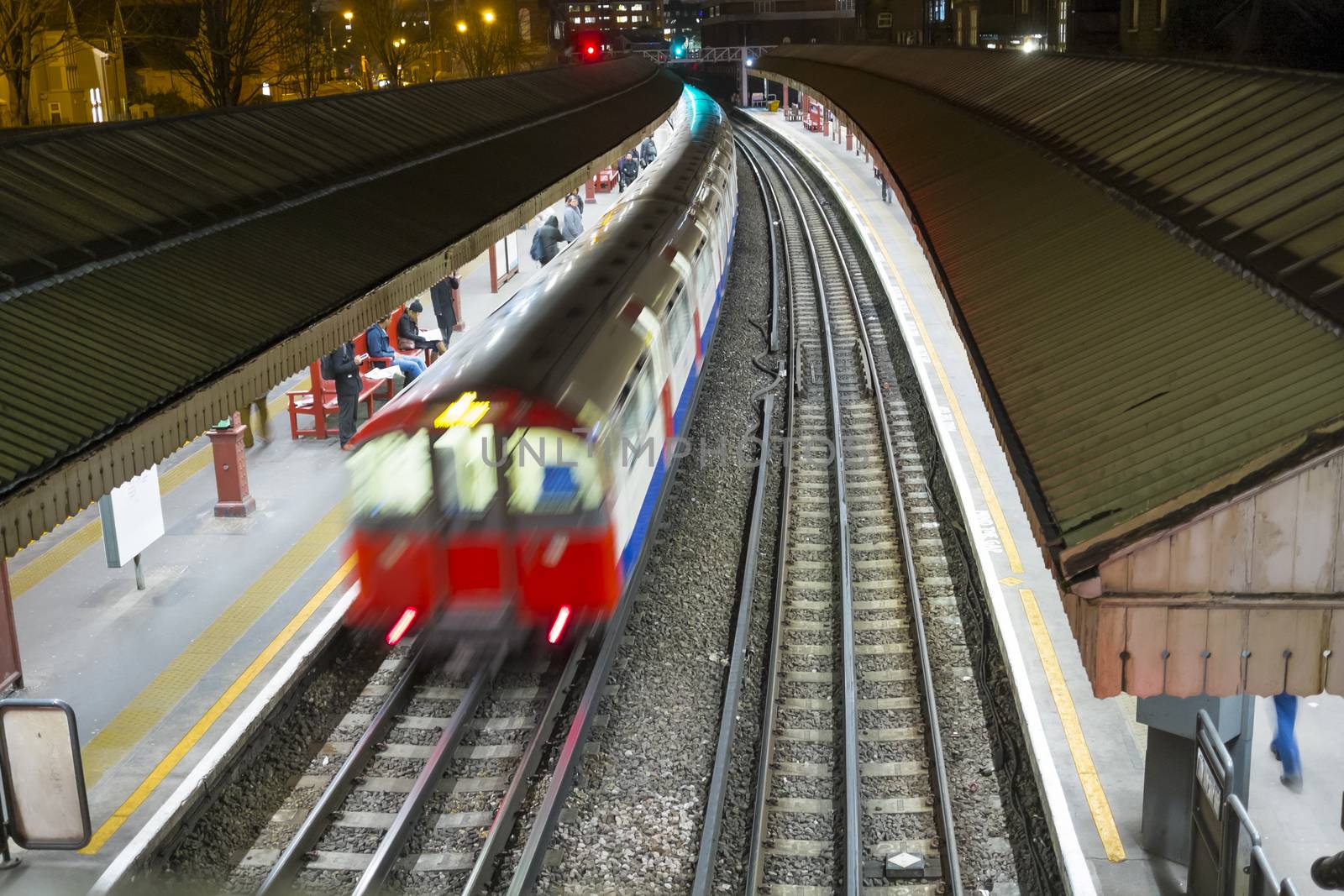 LONDON, UK - FEBRUARY 04: High angle motion blurred shot of Underground train in Baron's Court station. February 04, 2015 in London.