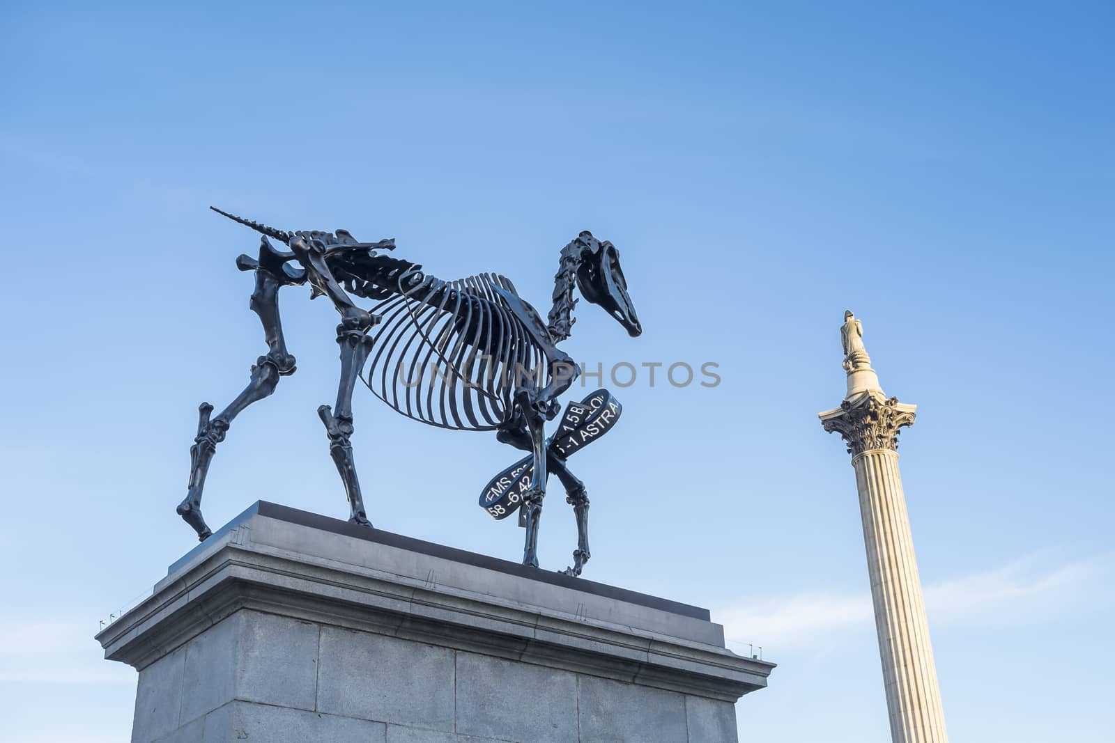 LONDON, UK - MARCH 06: Gift Horse sculpture by Hand Hacke, with Nelson's Column in the background, in Trafalgar Square. March 06, 2015 in London. The artwork shows live FTSE 100 tick in its ribbon.