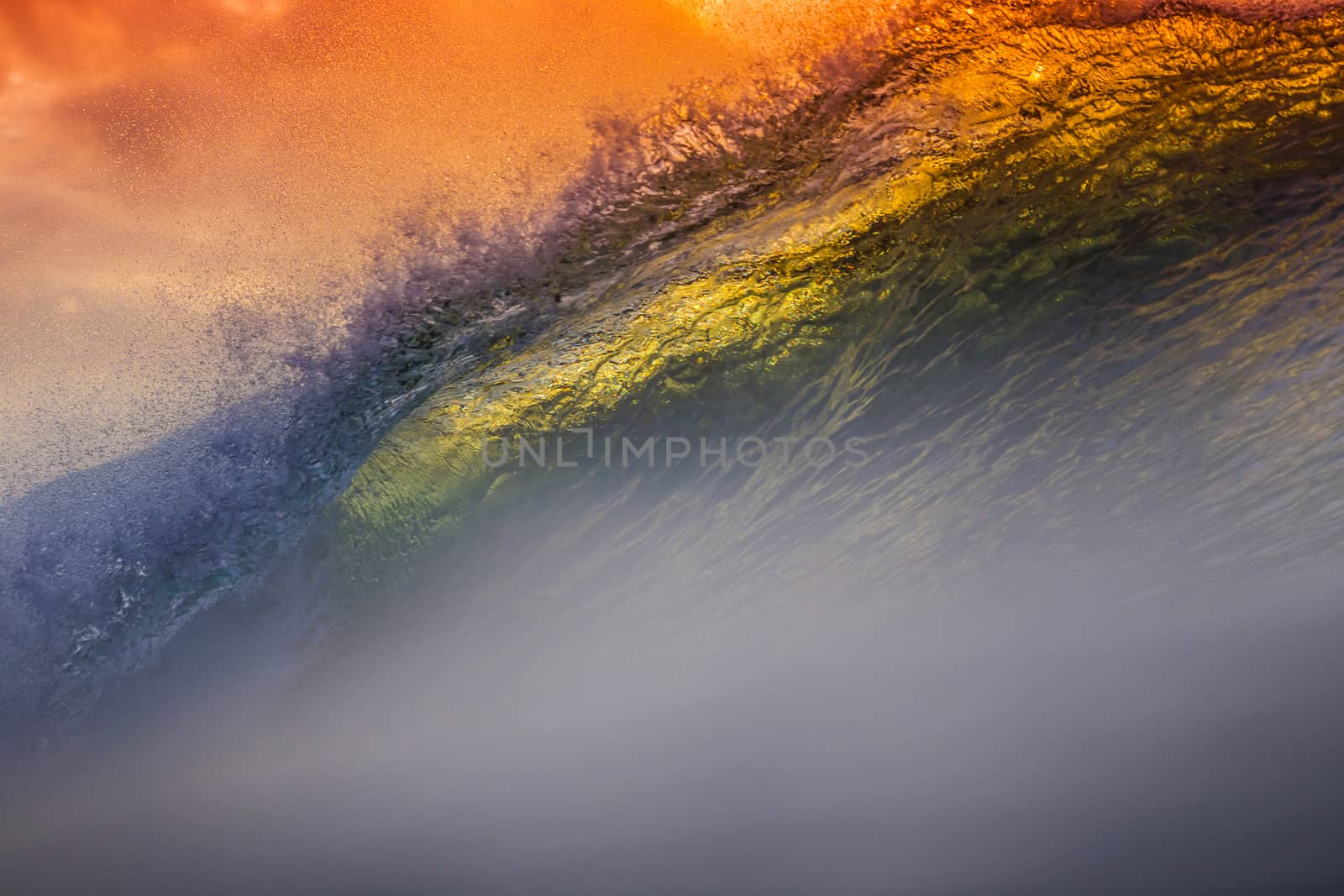 Colored Ocean Wave Falling Down at Sunset Time.