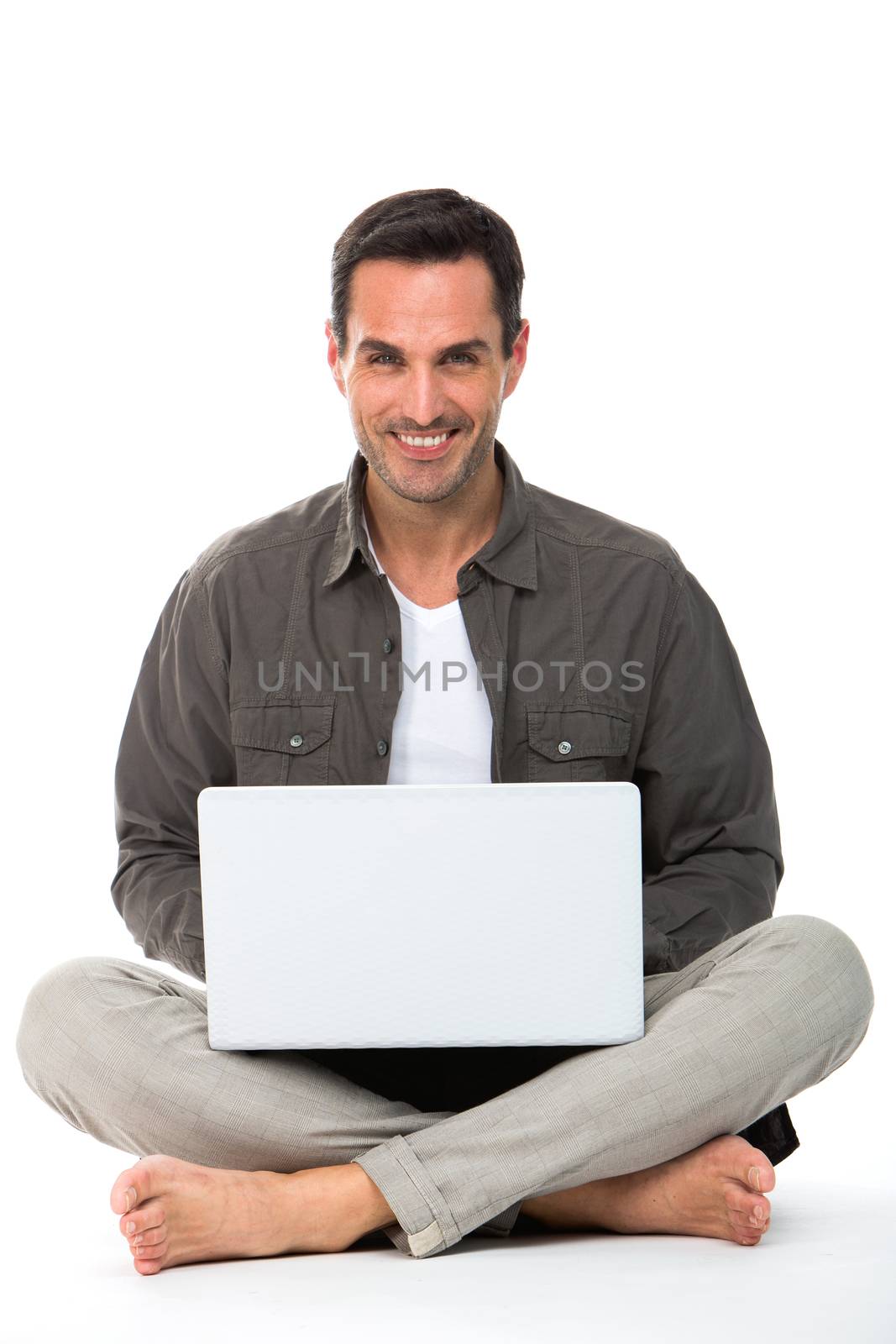 man seated on the floor with laptop by Flareimage