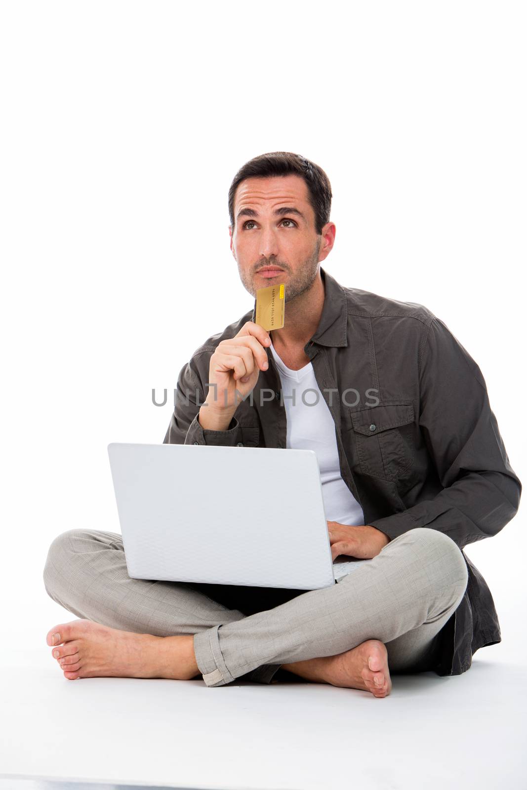 man seated on the floor with laptop by Flareimage