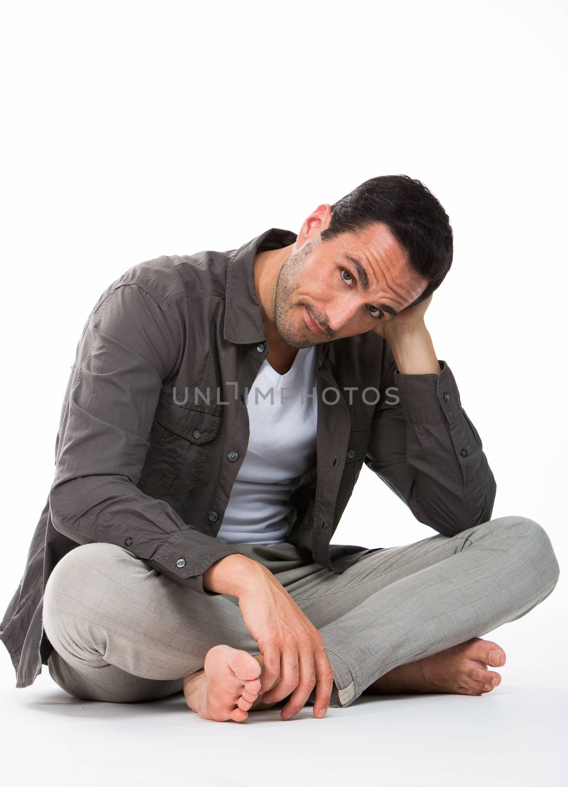 man seated on the floor by Flareimage
