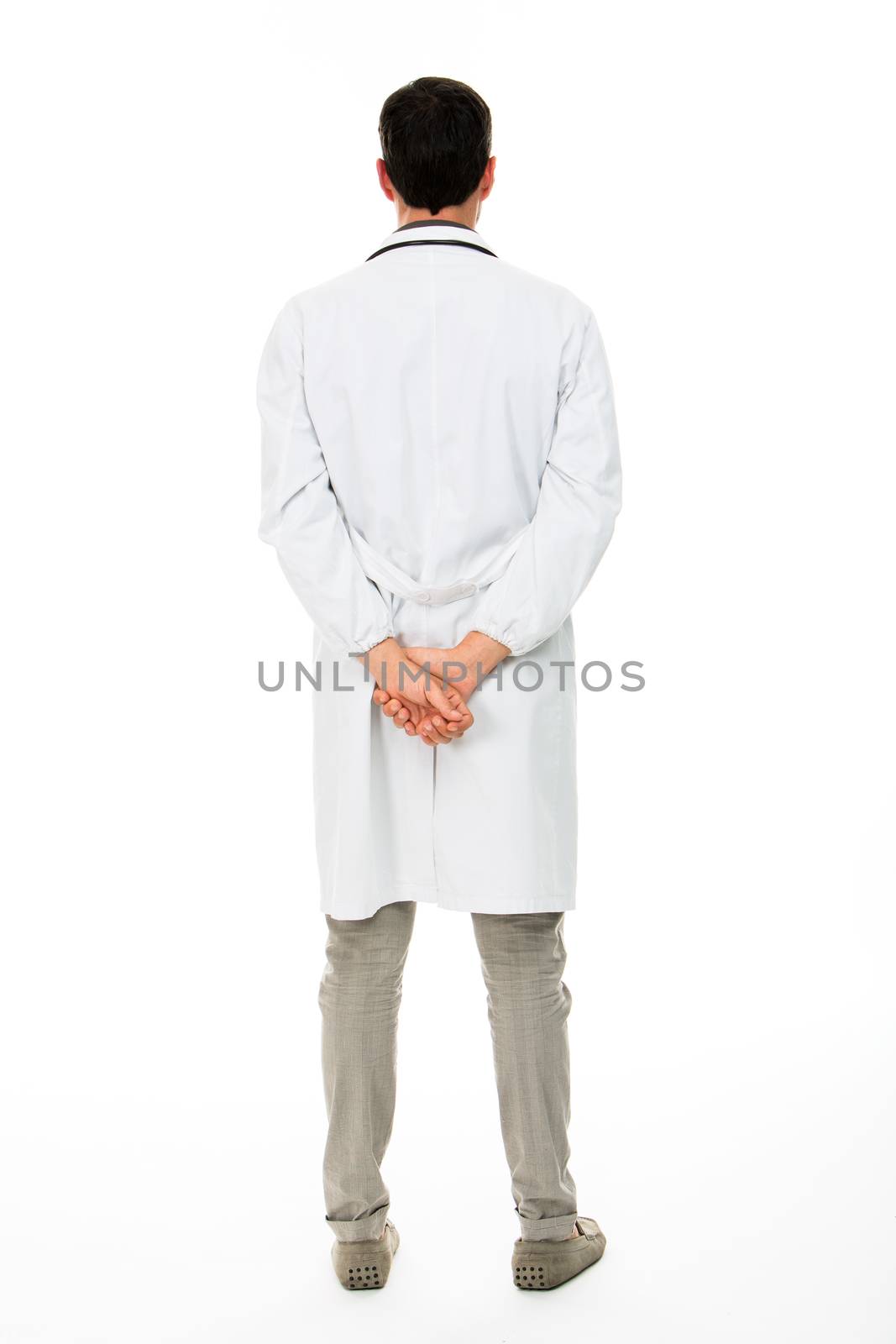 Full length backside view of a male doctor with hands behind his back