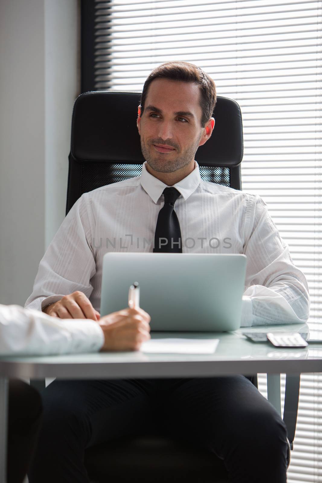 Two businesspeople having a meeting in the office using laptop computer 