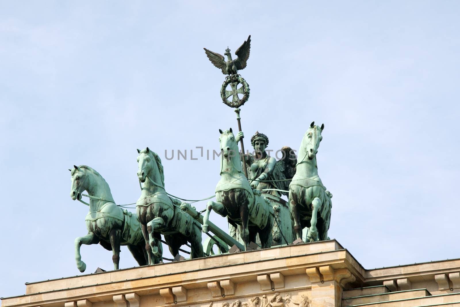 Detail of Brandenburg Gate and the Quadriga bronze statue. In german it is called Brandenburger Tor and it's one of the few monuments that survived in the defeated capital town of Berlin after second world war. King Frederick William II of Prussia commissioned the Gate and Carl Gotthard Langhans built it from 1788 to 1791.