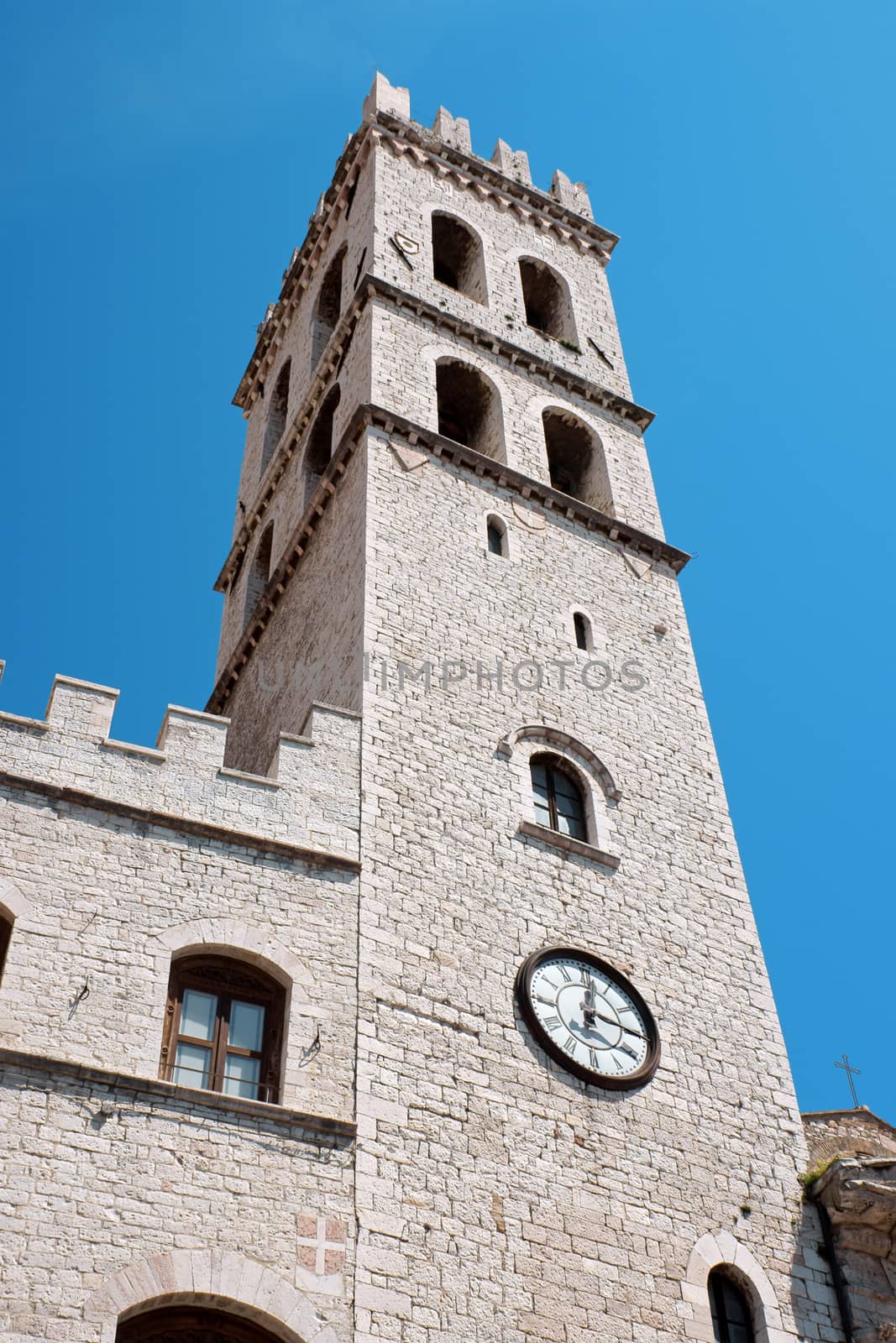 Detail of the ancient Palazzo del Capitano del Popolo, nowadays town hall and its tower in Assisi, a very well known touristic town in the italian province of Perugia (Umbria). The town was built on Mount Subasio.