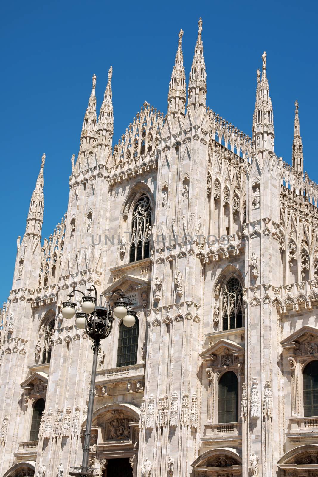 Gothic architecture of Milan Cathedral in Piazza del Duomo. It is the fourth largest church in the world. The construction started in 1386 and took about five centuries.