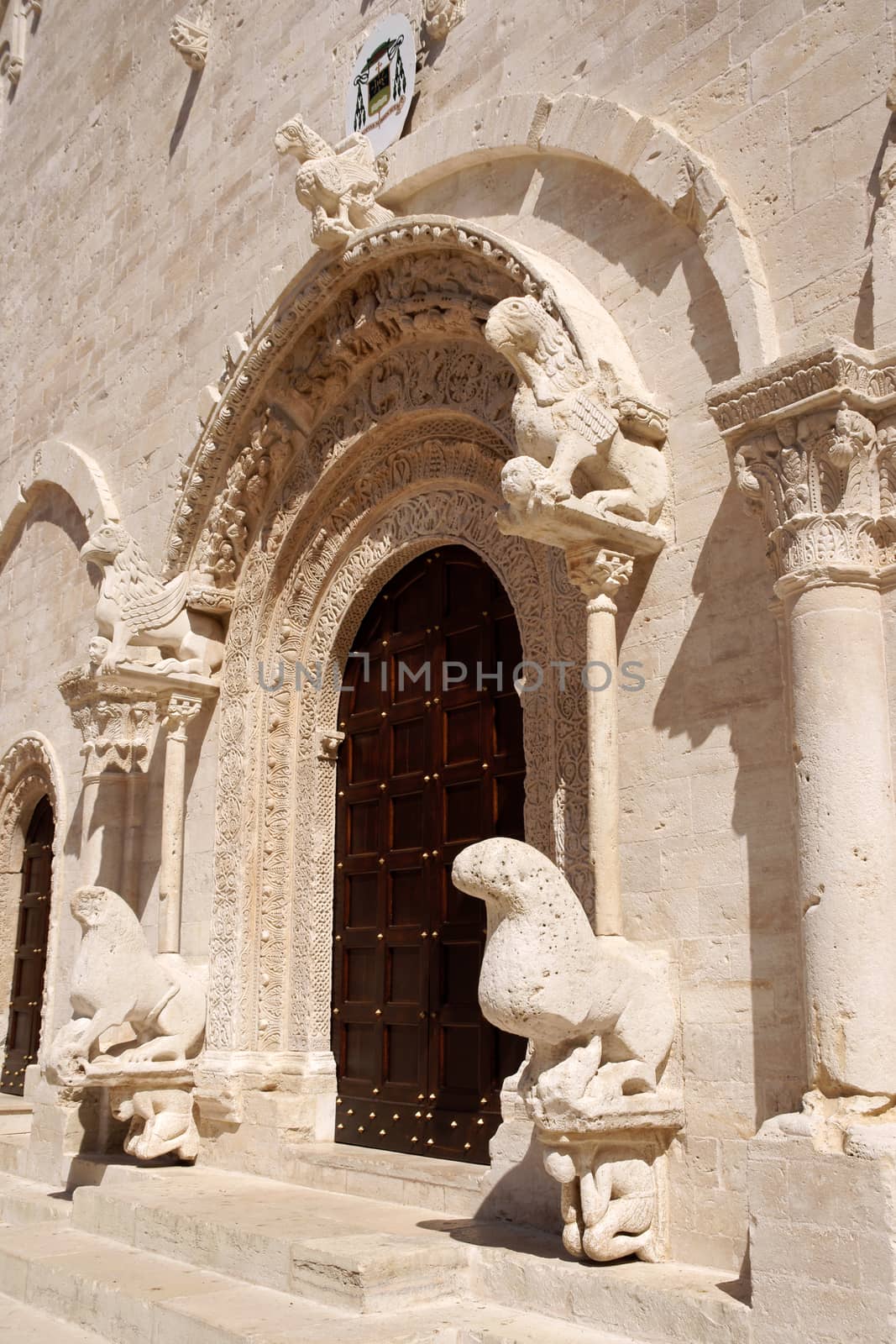 Portal of Ruvo di Puglia Cathedral in the southeast italian region of Apulia. The simple but elegant facade shows a lot of statues with vegetal, animal and human details. The Cathedral was dedicated to Santa Maria Assunta and was built between 12th and 13th century.