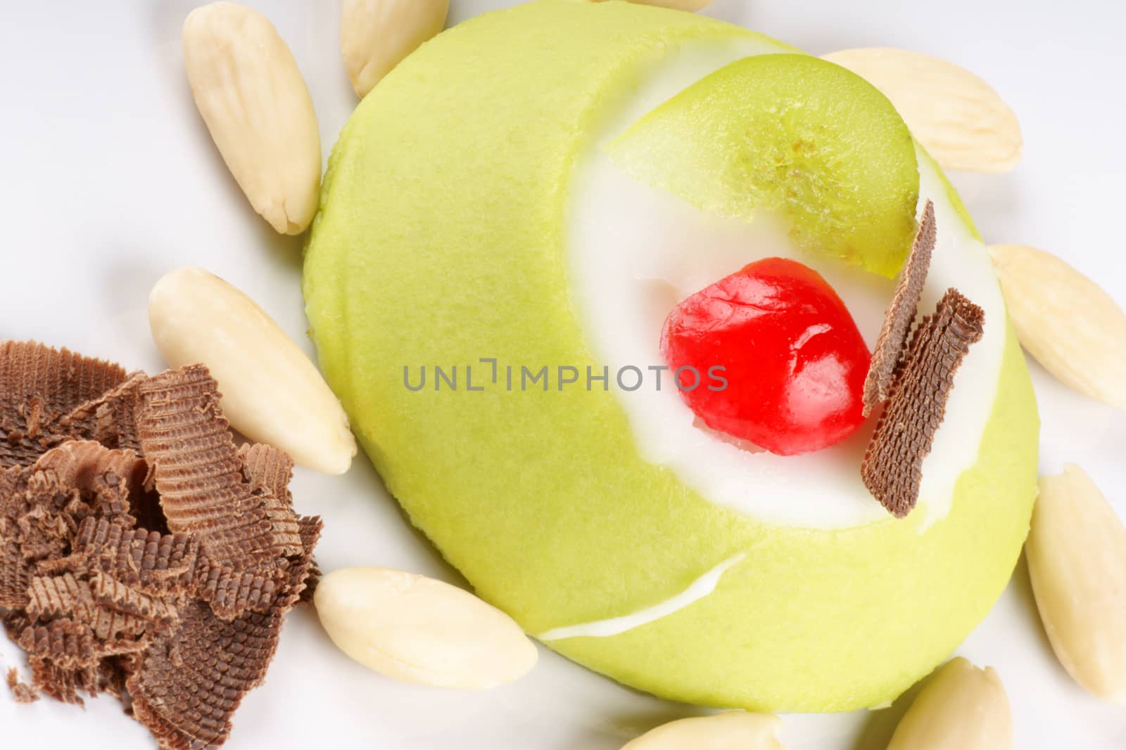 Close-up of a mini sicilian cassata with pieces of candied fruit, chocolate and almonds