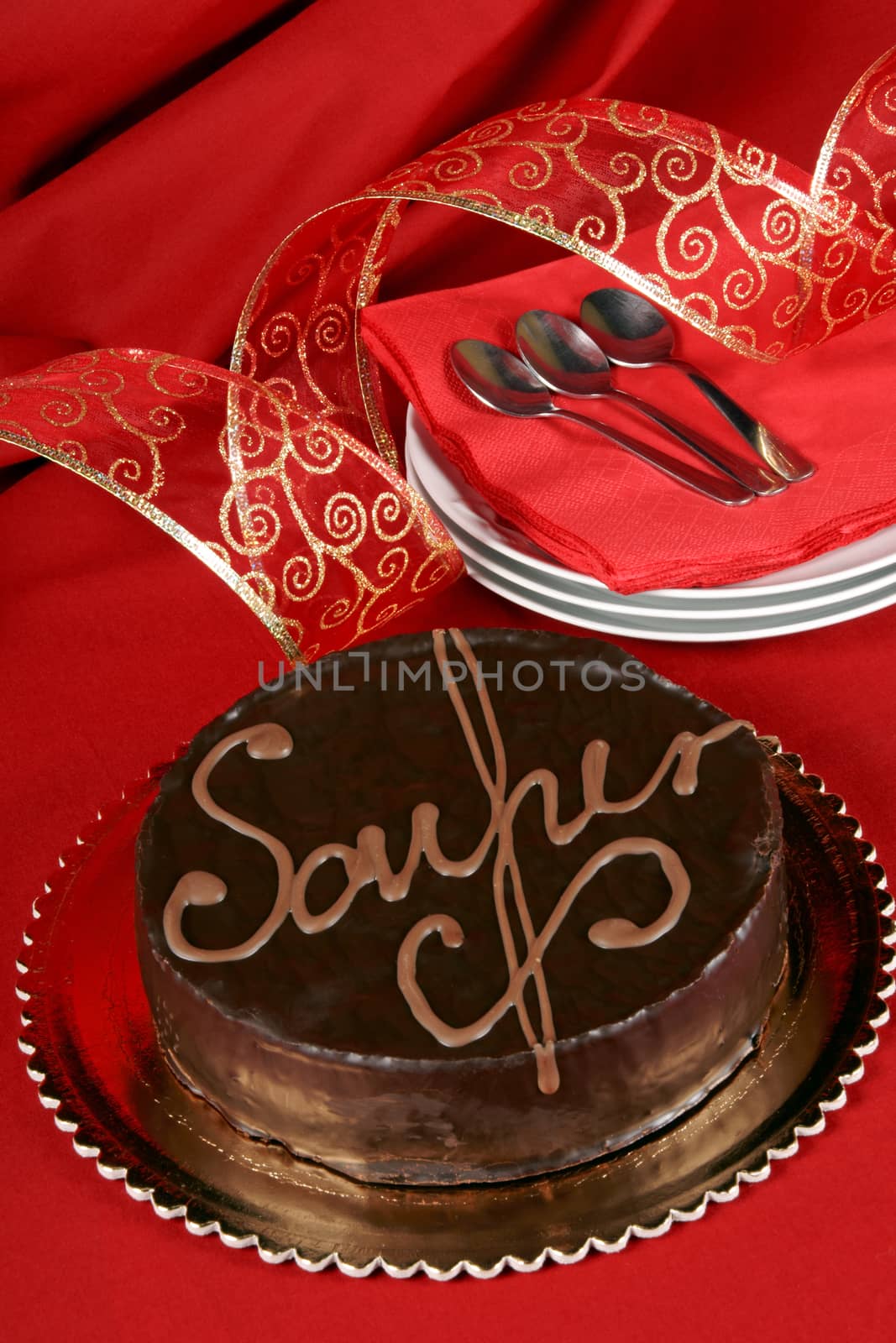 Famous austrian chocolate cake called sacher torte served on a golden plate. Selective focus.