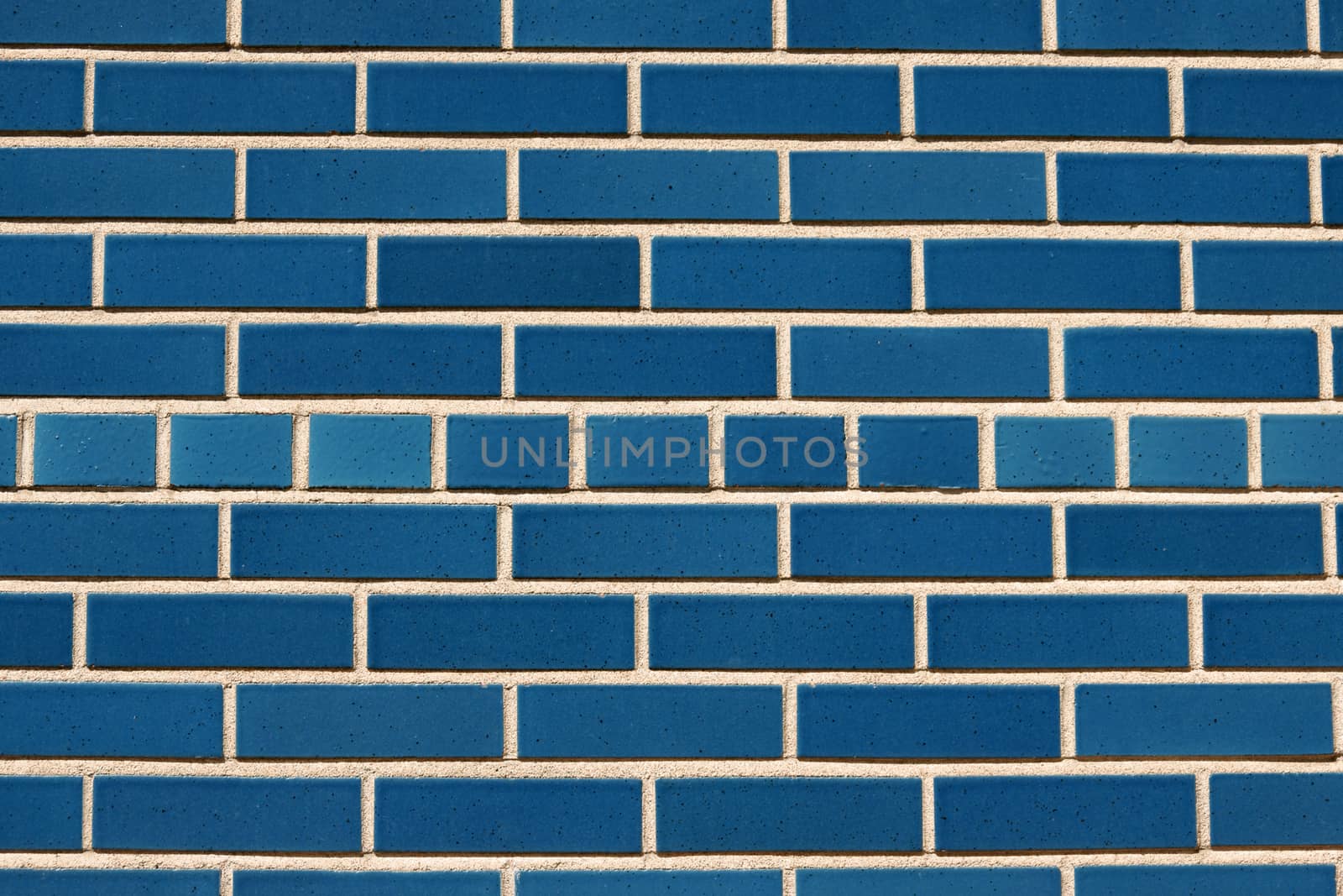 Outdoor wall made of blue ceramic bricks perfect as background or texture