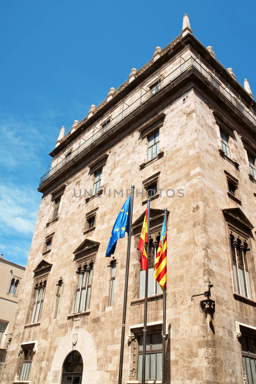 Palau de la Generalitat, a 15th century gothic palace, currently used as the seat of the regional government, the Generalitat Valenciana. In front of the palace wave the flags of European Community, Spain and Valencian Community.