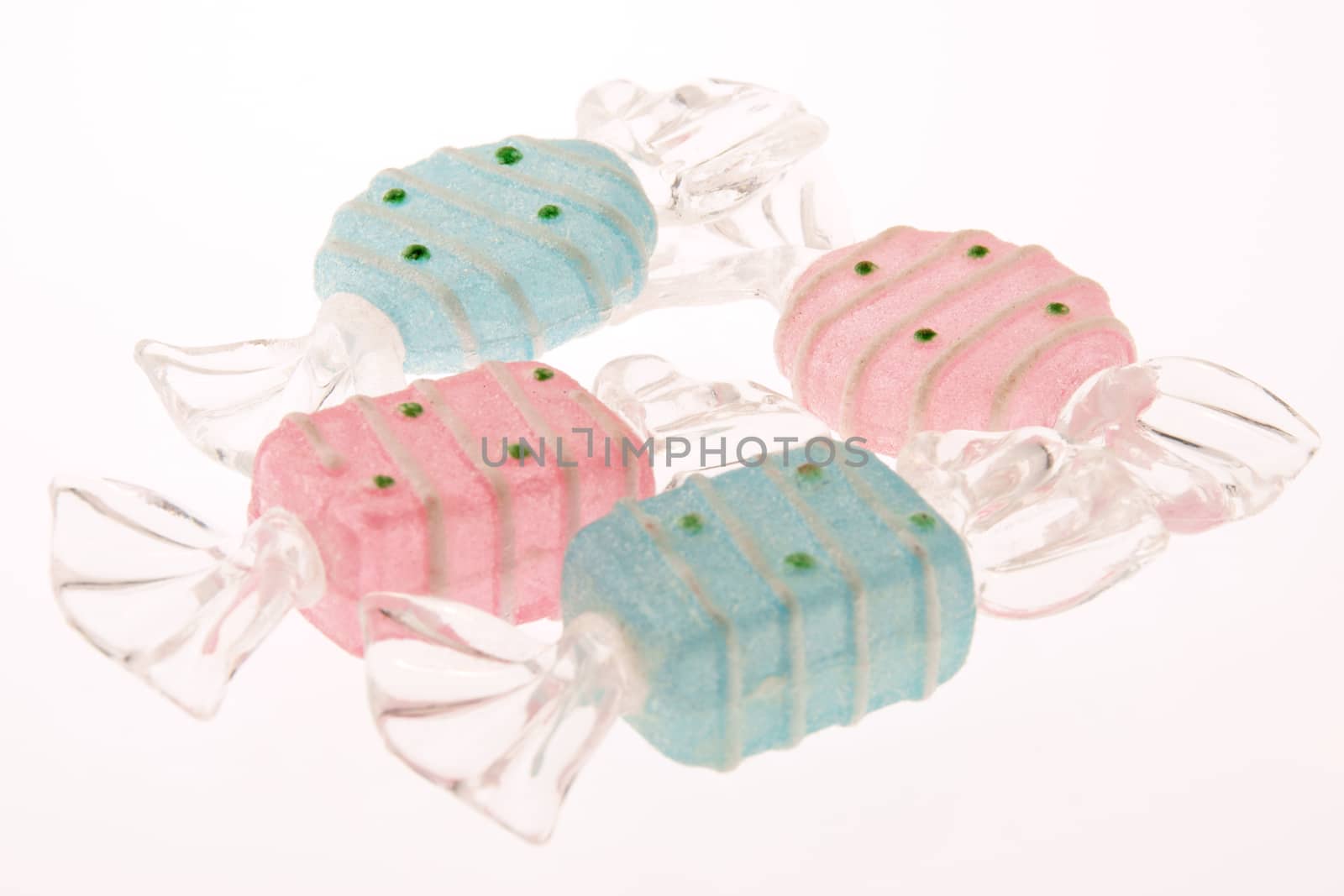 Cyan and pink plastic candy shaped Christmas ornaments over white background. Selective focus. Shallow DOF.