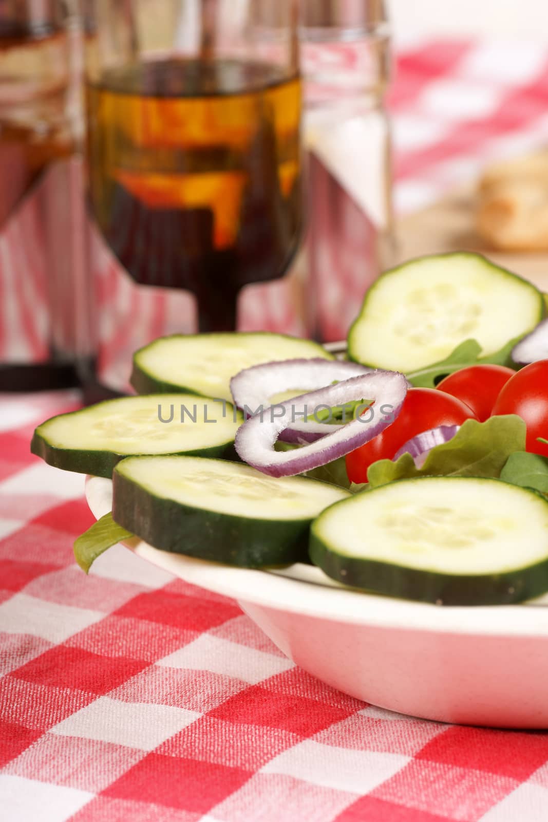 Close-up of a fresh mixed salad served in a dish on a set table.