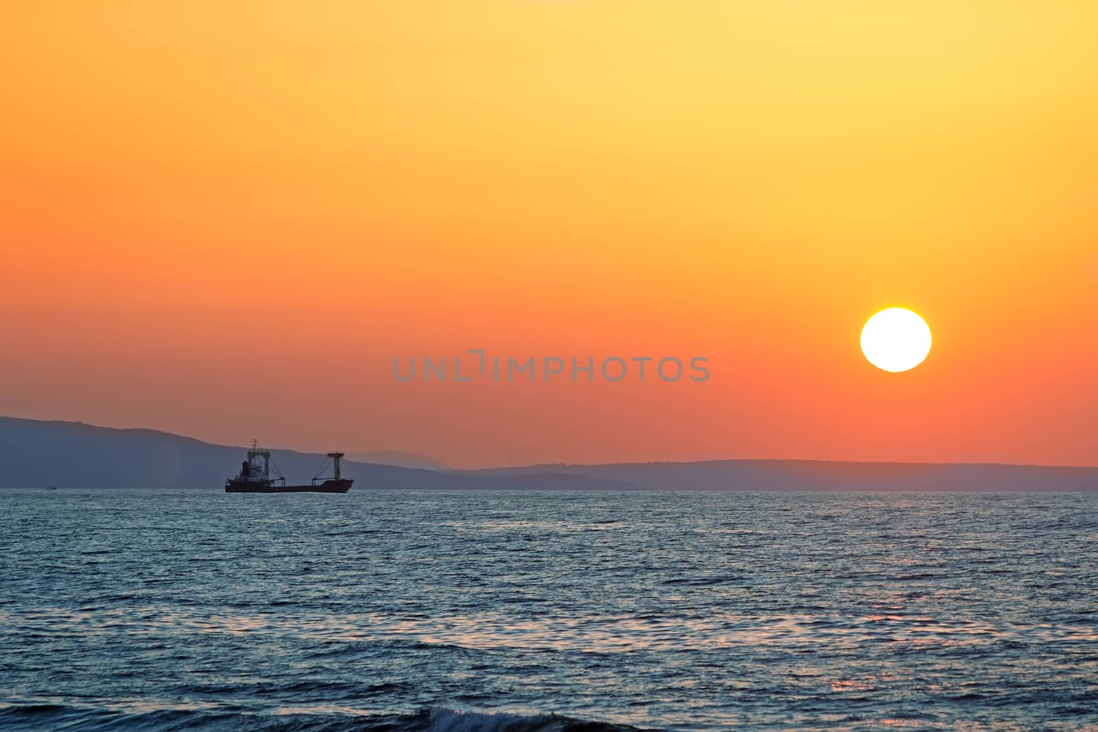 Sunset at sea off the coast of the Mediterranean sea.