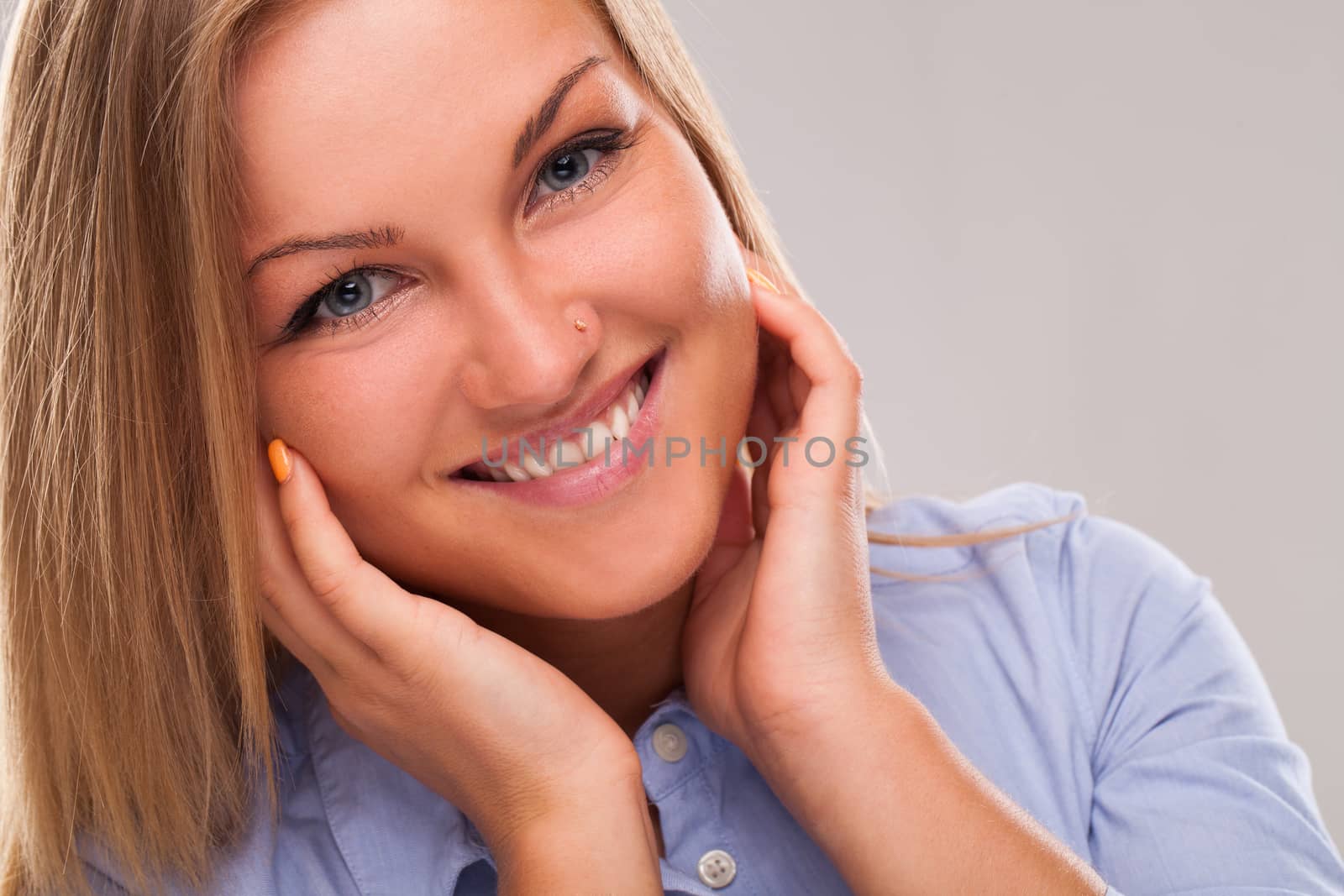 Closeup portrait of young blond caucasian woman smiling