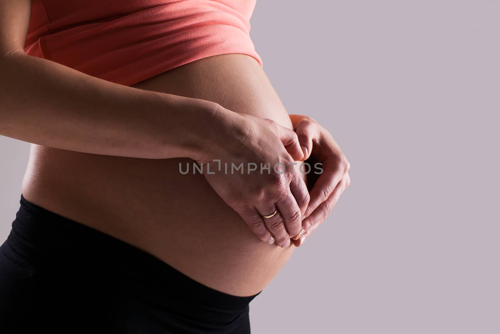 Beautiful pregnant belly on a grey background